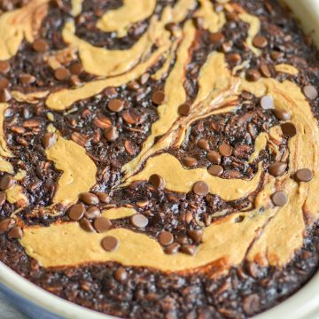 Close up of Chocolate Chip Baked Oats with Peanut Butter swirl in a baking dish.