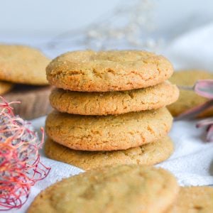 a stack of four cookies on a white cloth