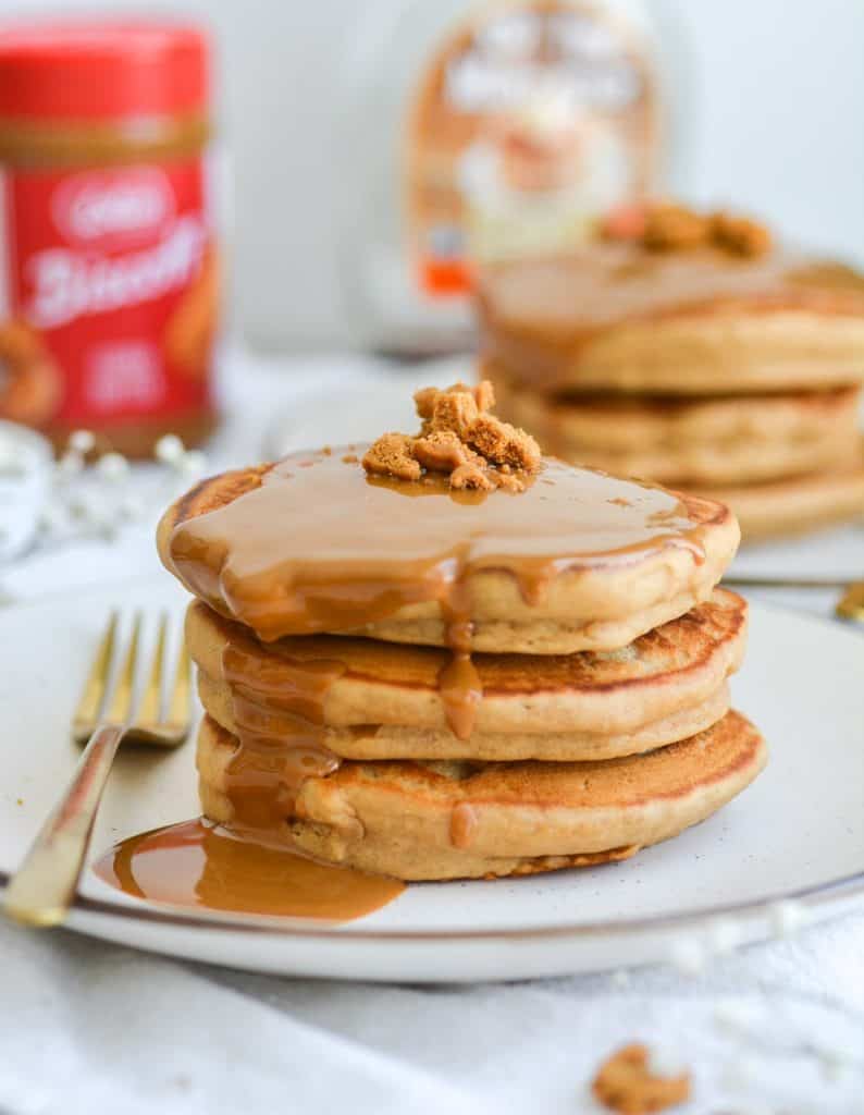 Portrait of two stacks of pancakes with cookie butter dripping down the side of the stack