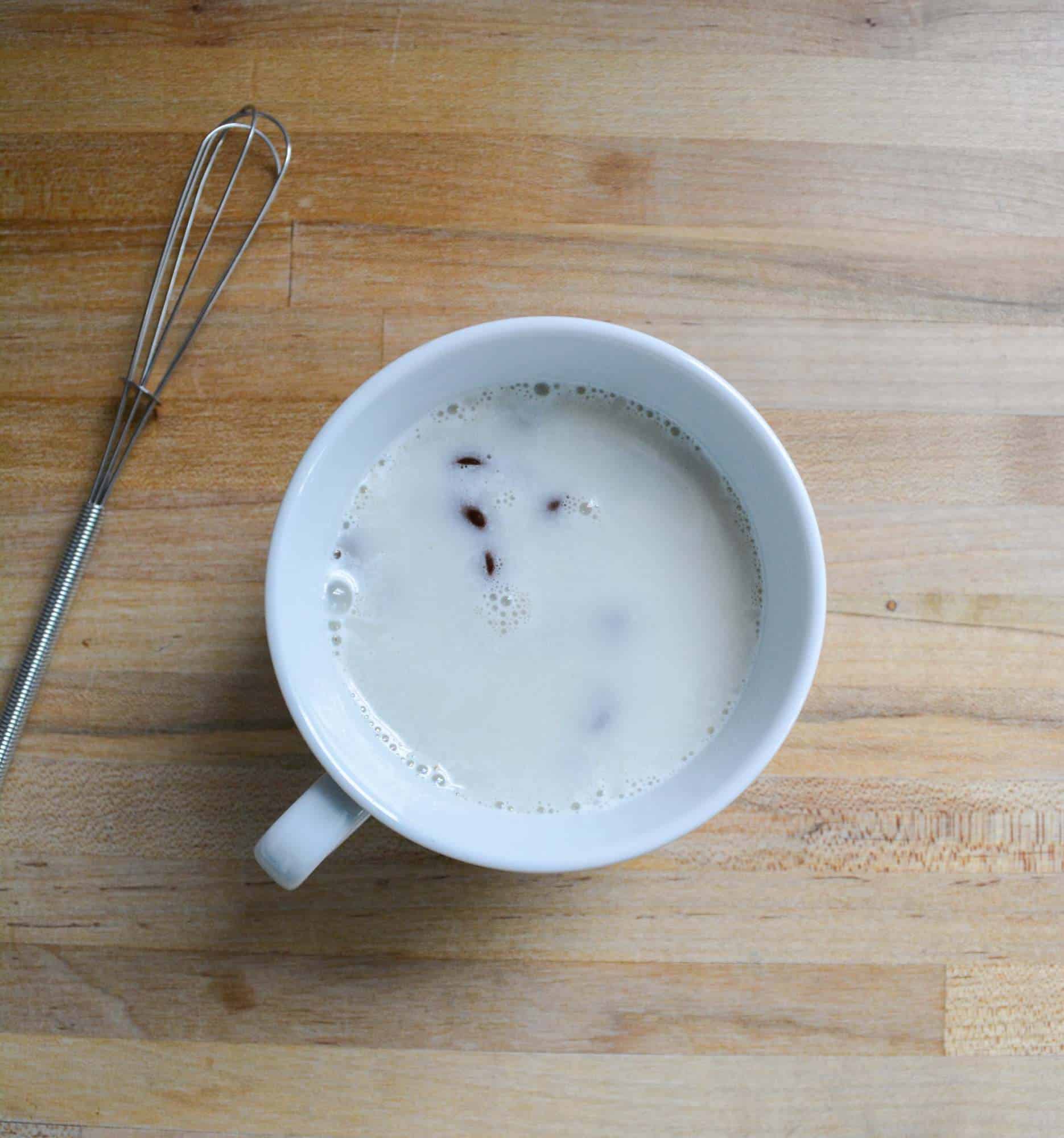 chocolate chips and vegan milk in a small mug