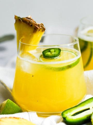Pineapple Jalapeno Margarita in a glass garnished with a pineapple wedge