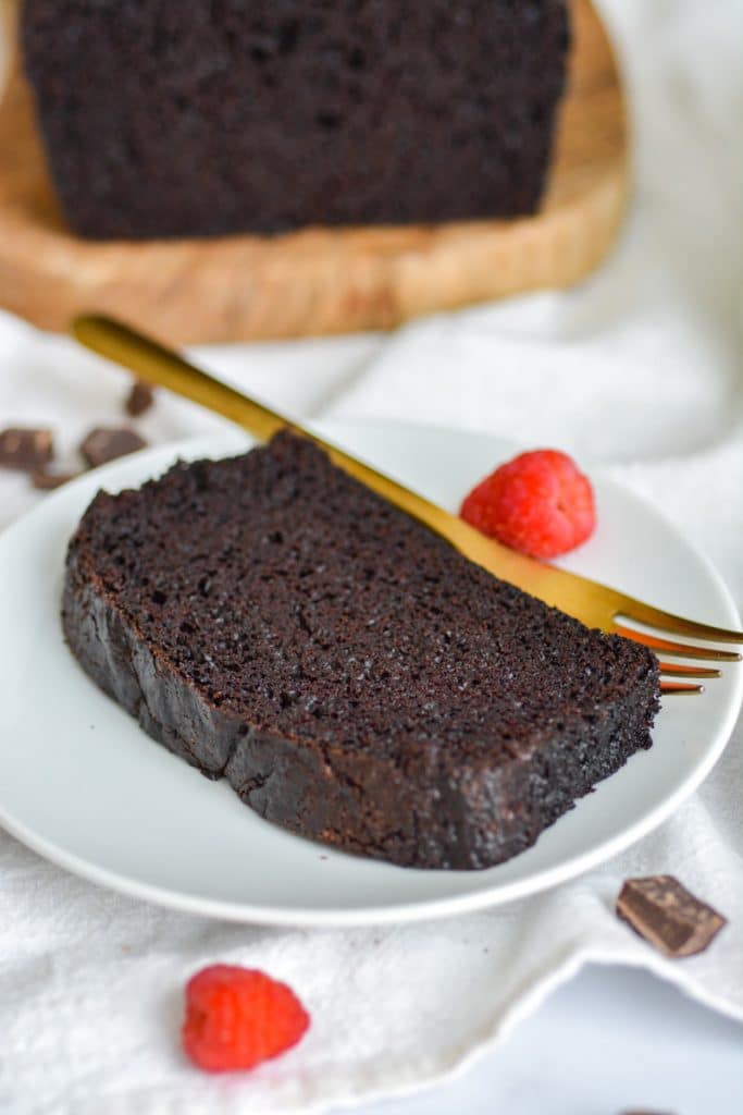 A slice of chocolate cake made with oil on a white plate