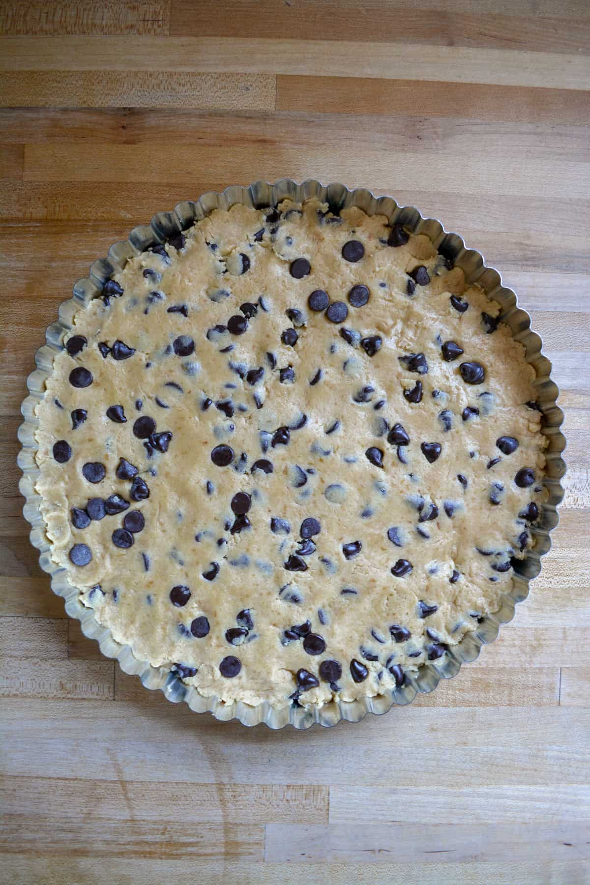 Unbaked cookie cake in a tart pan