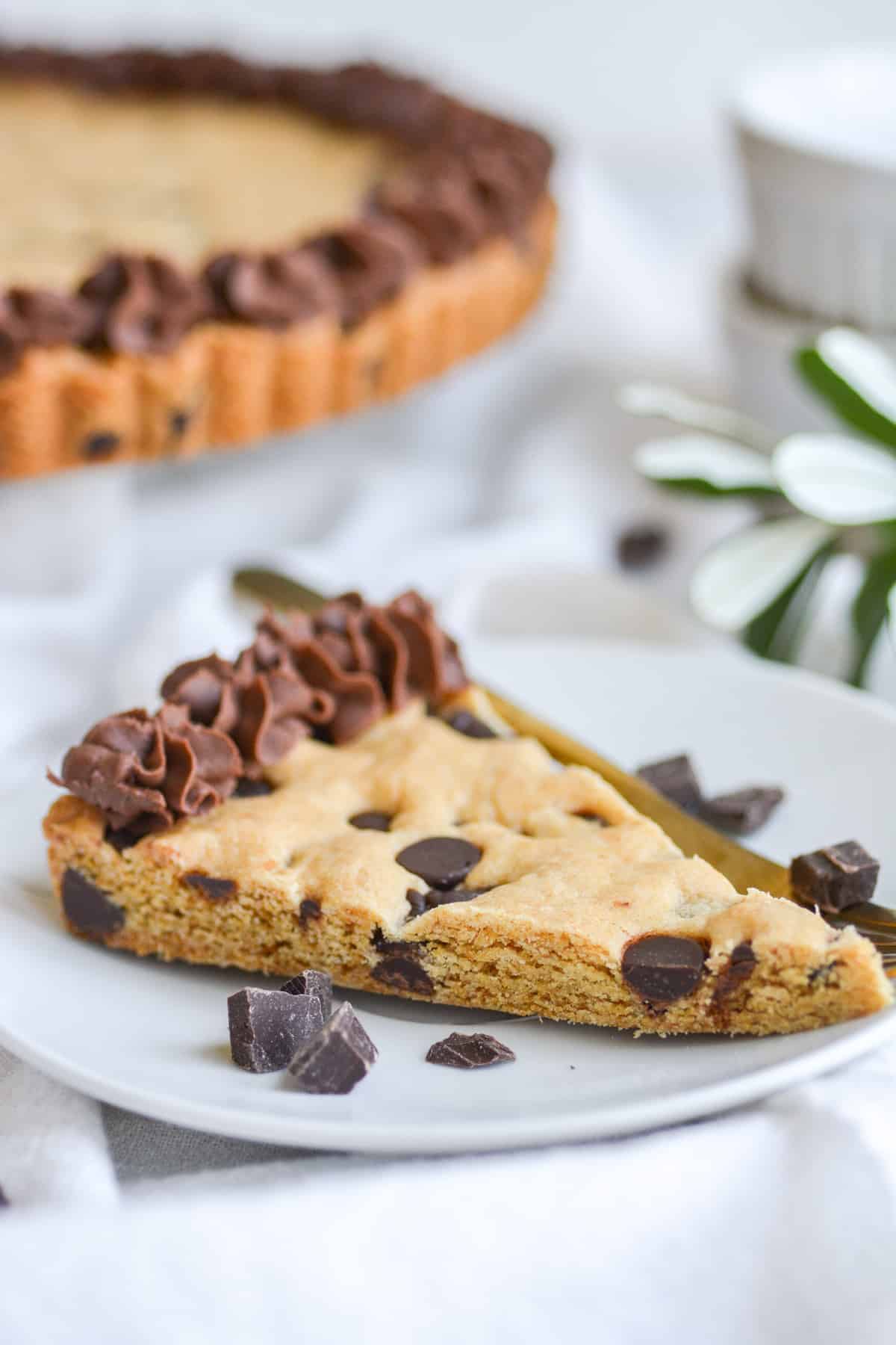 Slice of Vegan Cookie cake on a plate on a white cloth