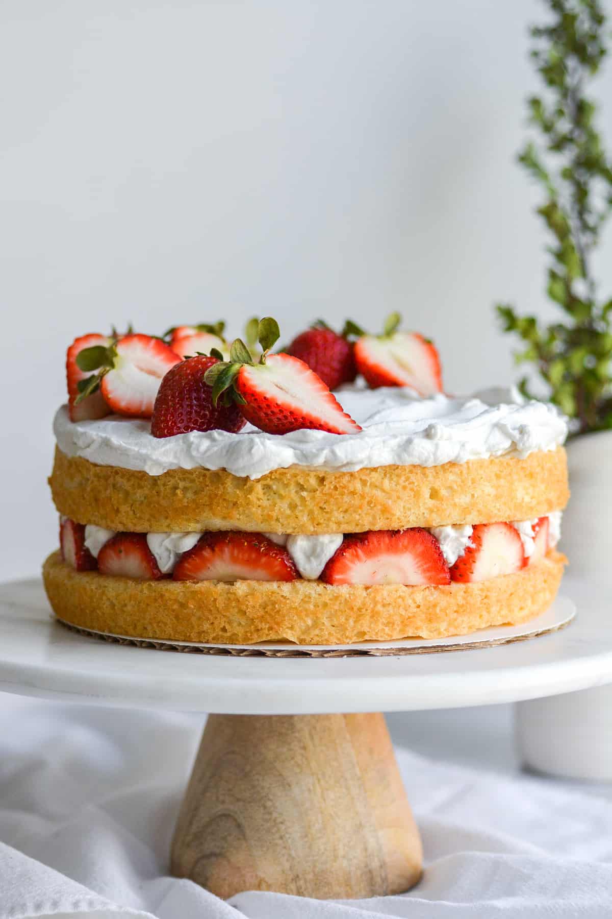 Vegan Strawberry Shortcake Birthday Cake on a cake stand