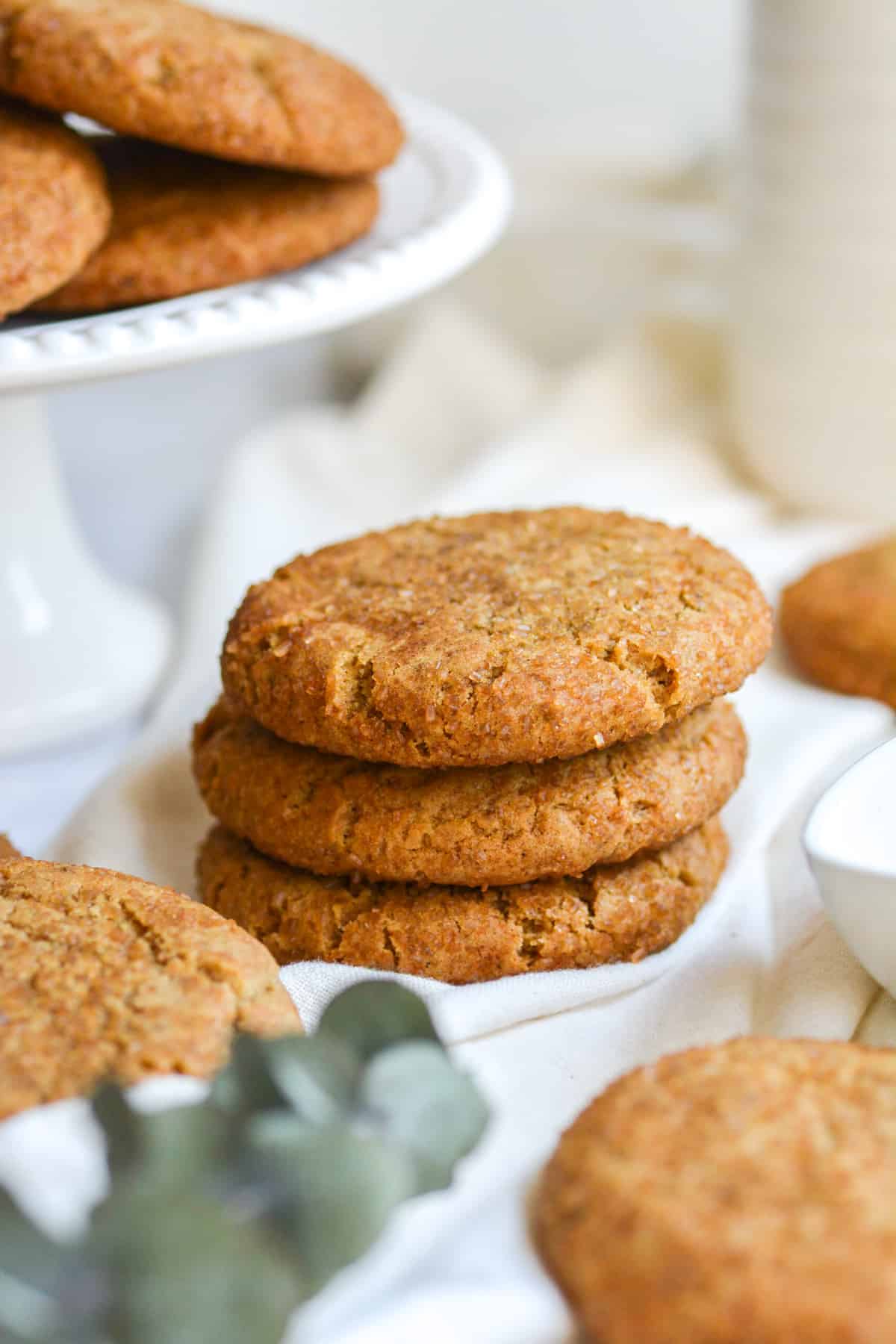 A stack of 3 vegan chai cookies on a white cloth