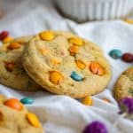 vegan cookies on a white cloth with vegan m&ms scattered arount