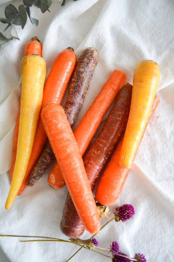 Rainbow carrots on a white cloth