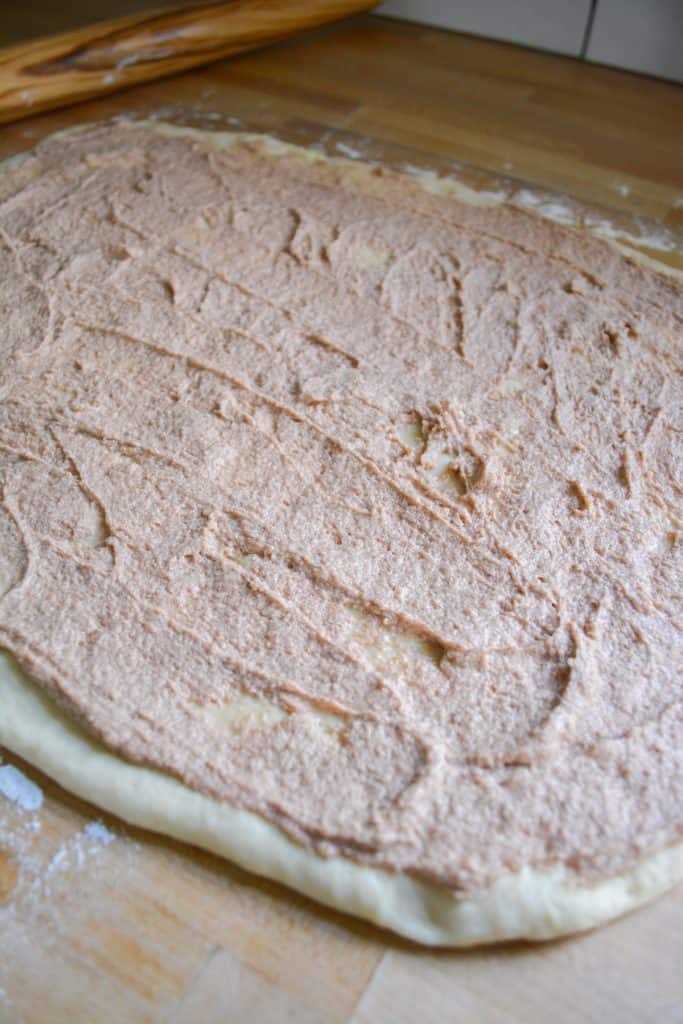 rolled out dough spread with filling