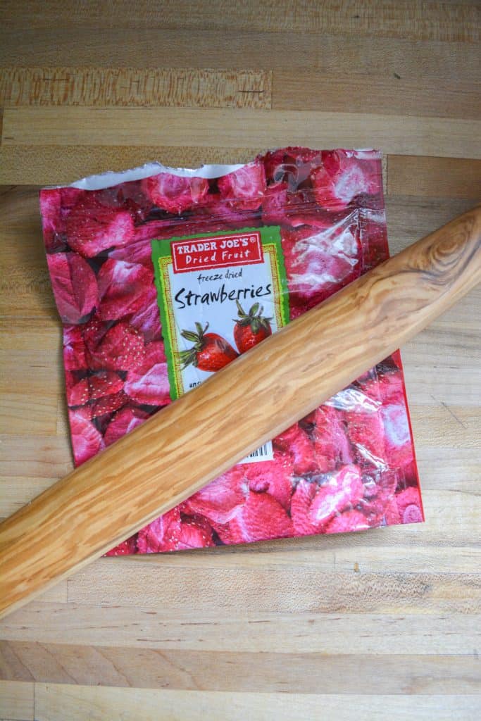 Rolling pin on a bag of freeze dried strawberries