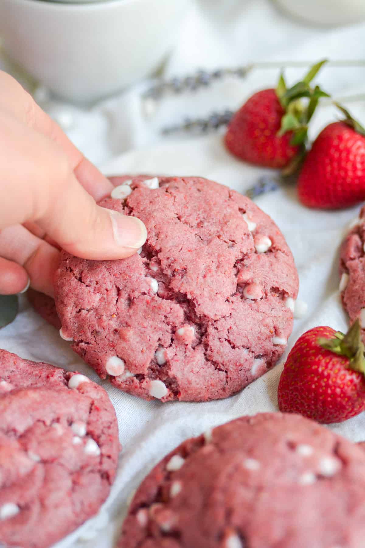 hand holding a vegan strawberry cream cheese cookie