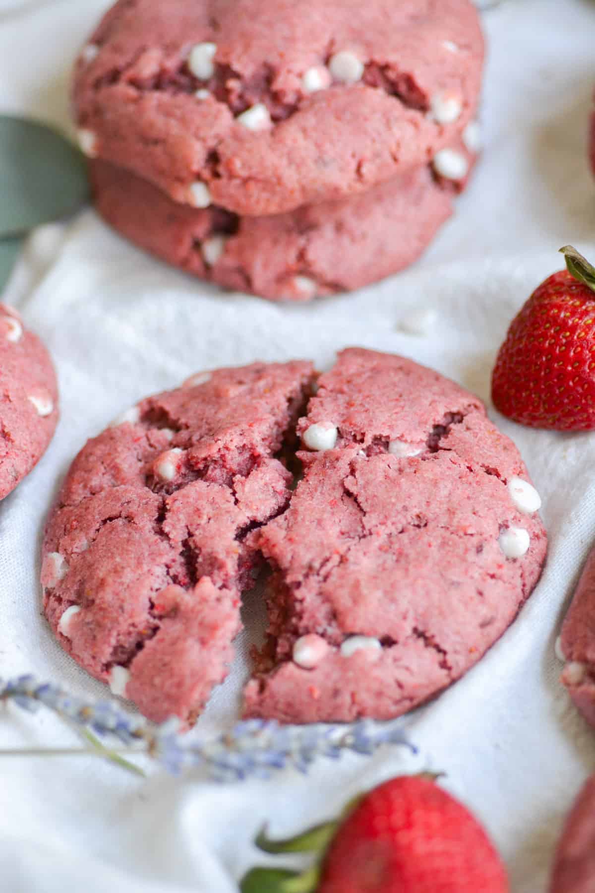 vegan strawberry cheesecake cookie broked open on a white cloth