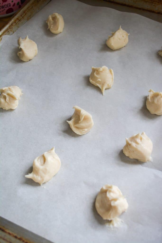cream cheese mounds on a parchment lined baking sheet
