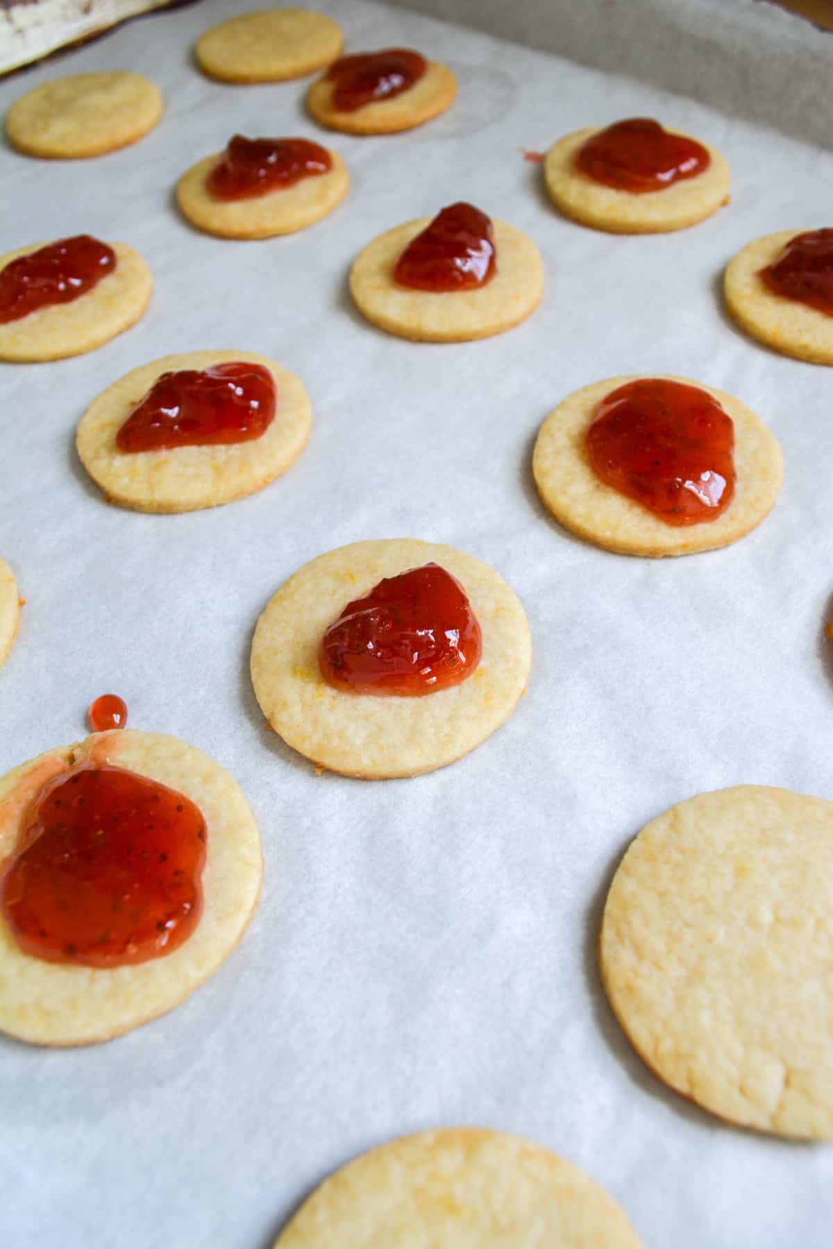 Baked linzer cookie bottoms topped with strawberry jam.
