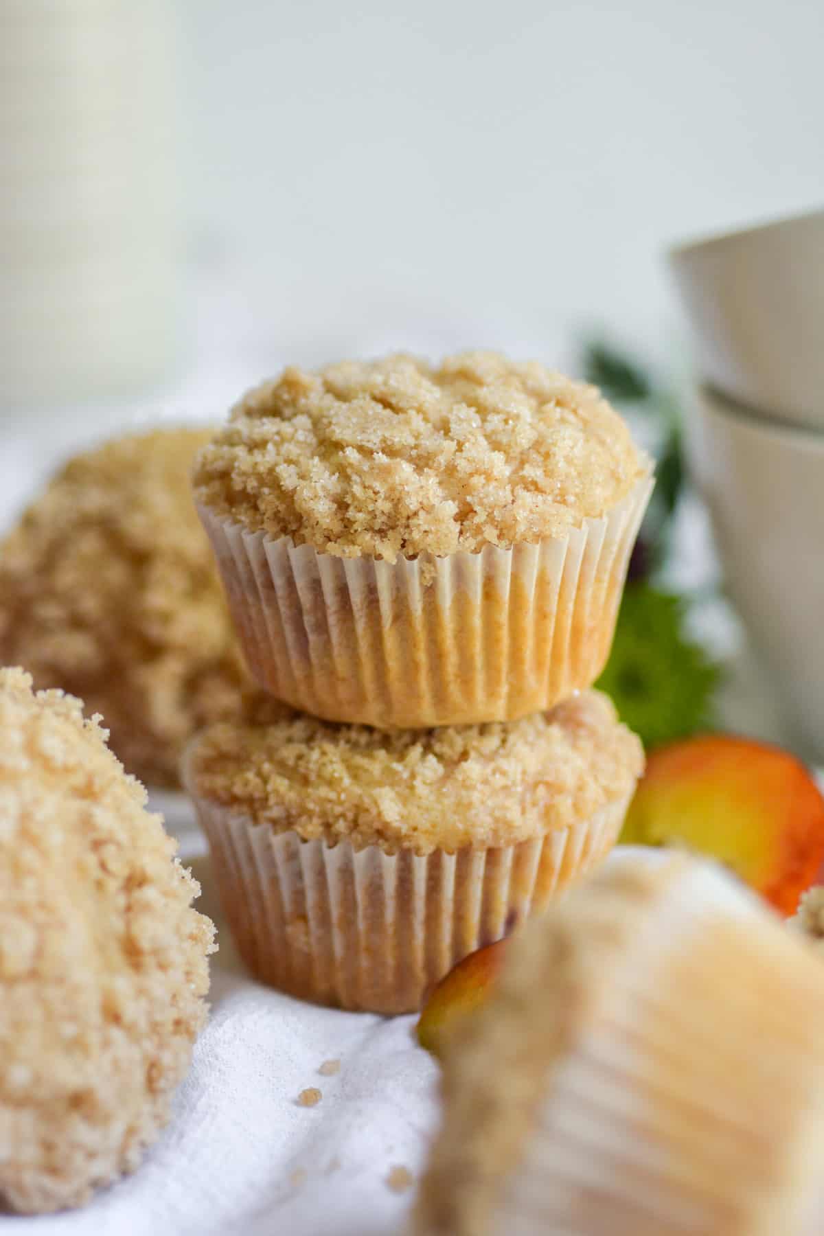 Two Vegan Peach Coffee Cake Muffins stacked