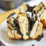 broken open oreo cinnamon roll on a white plate
