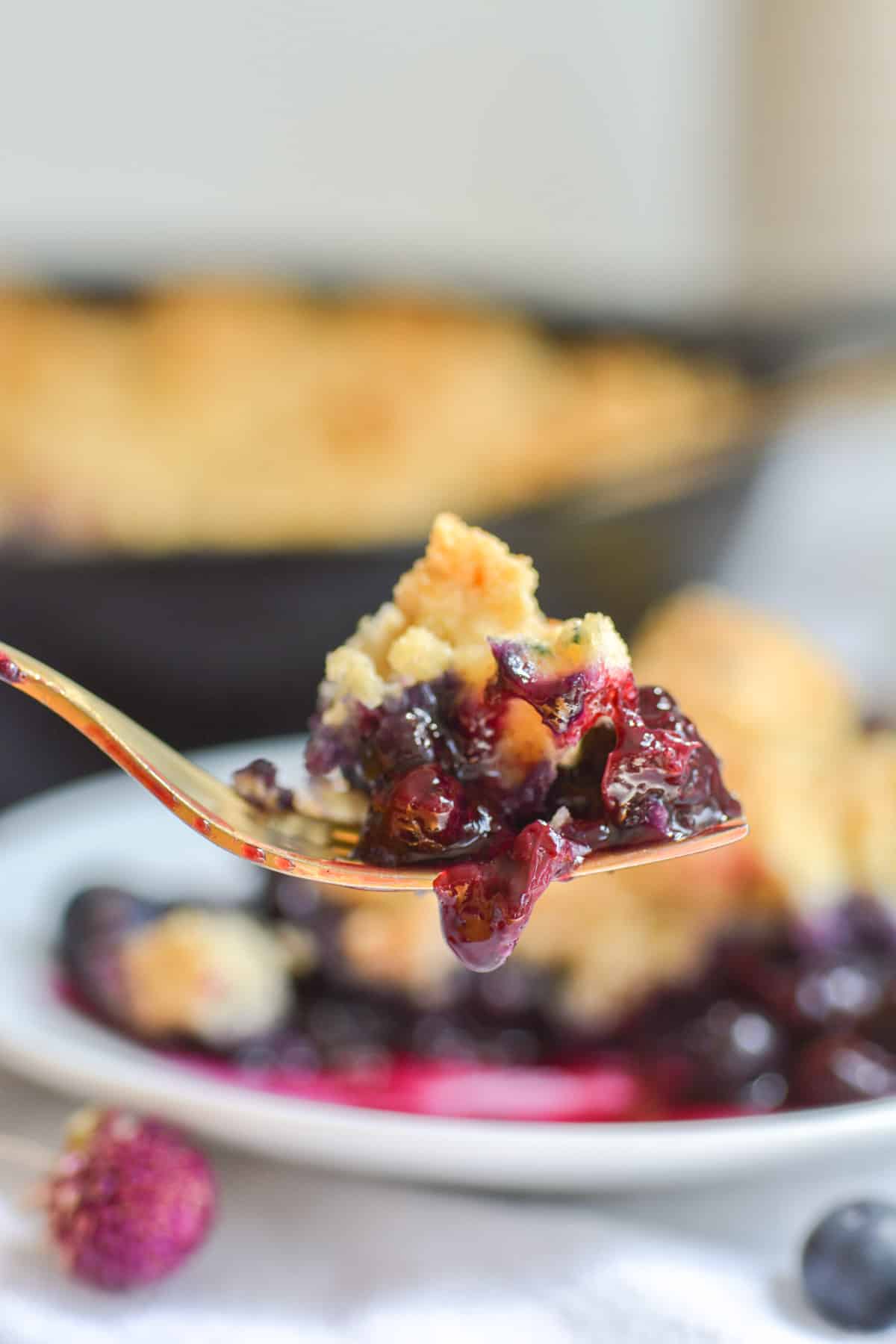 A bite of vegan dairy free blueberry cobbler on a fork