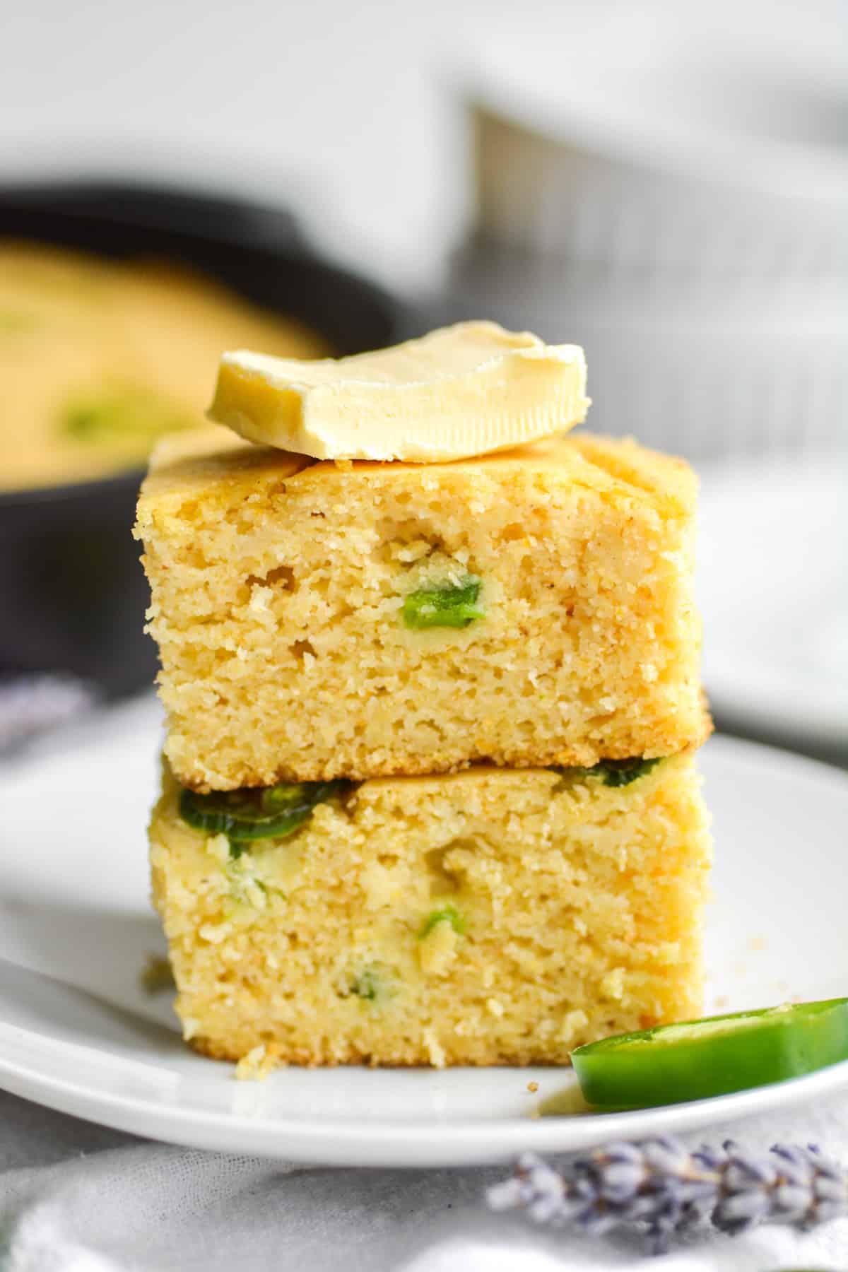 two pieces of vegan jalapeño cornbread stacked on top of eachother.