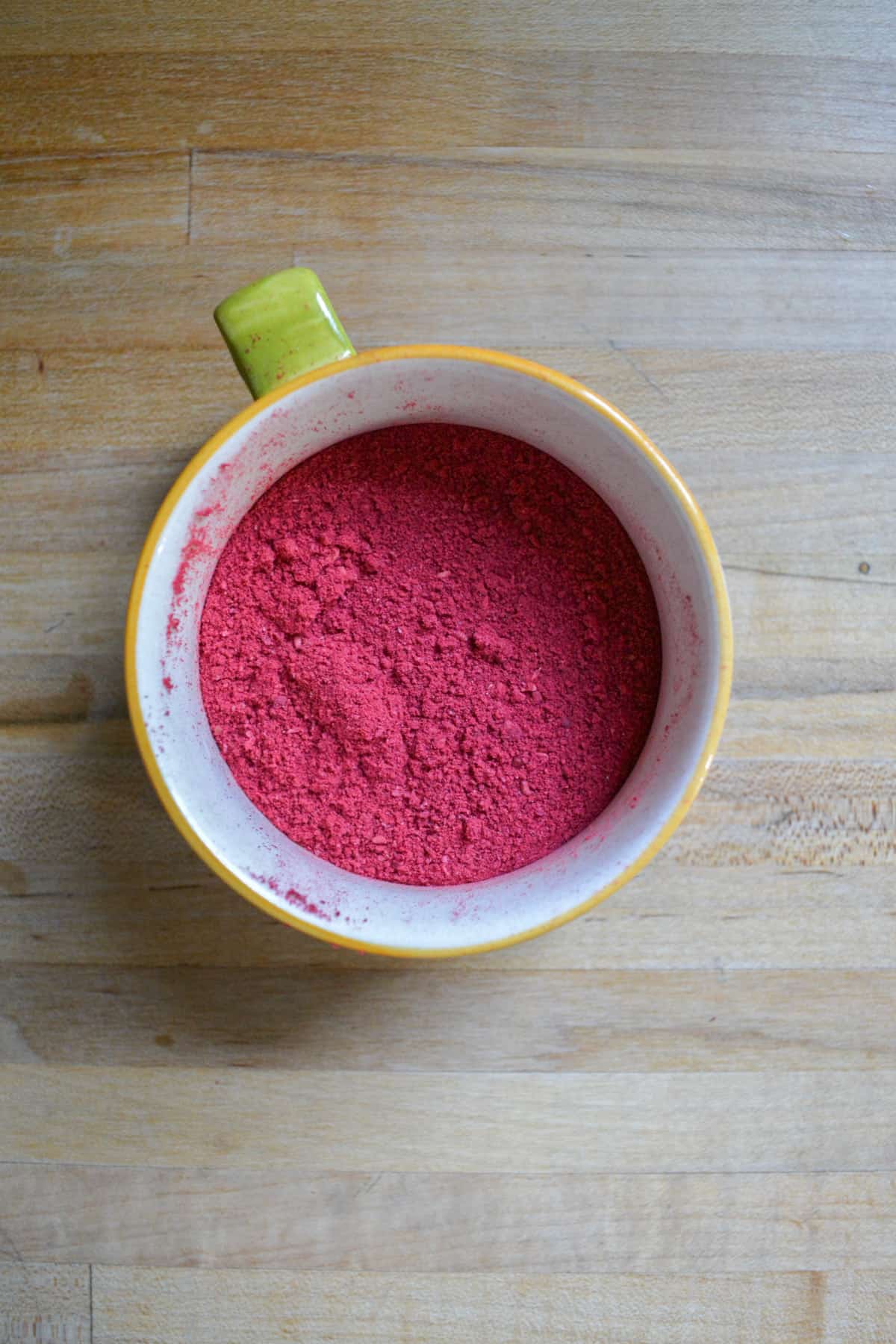 crushed freeze dried raspberries in a small cup