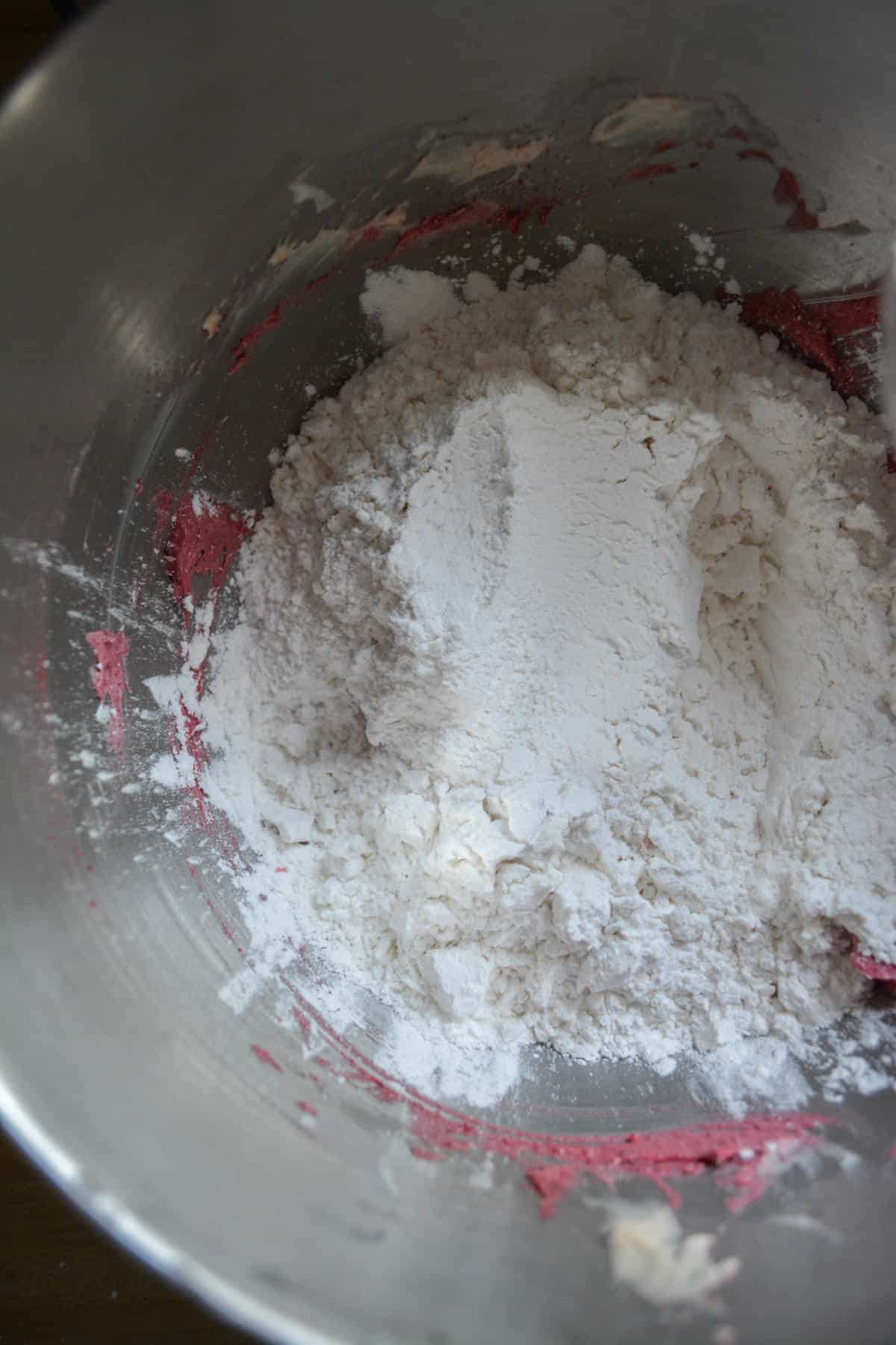 adding powdered sugar to frosting