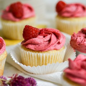 vegan lemon raspberry cupcakes on a white cloth