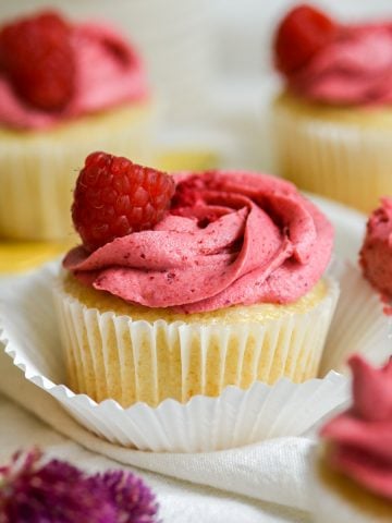 vegan lemon raspberry cupcakes on a white cloth