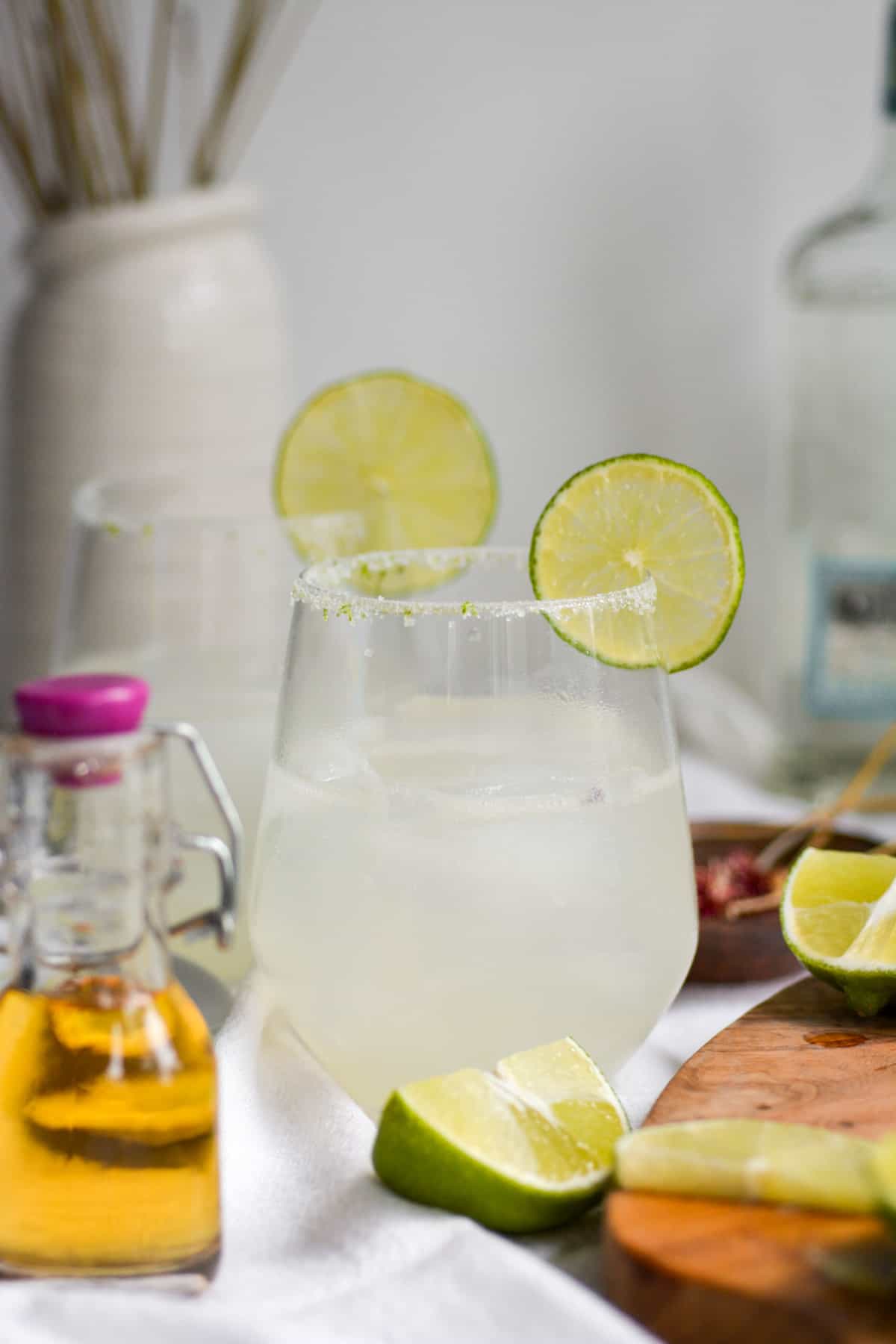 Straight on shot of seltzer margaritas garnished with a lime wheel.