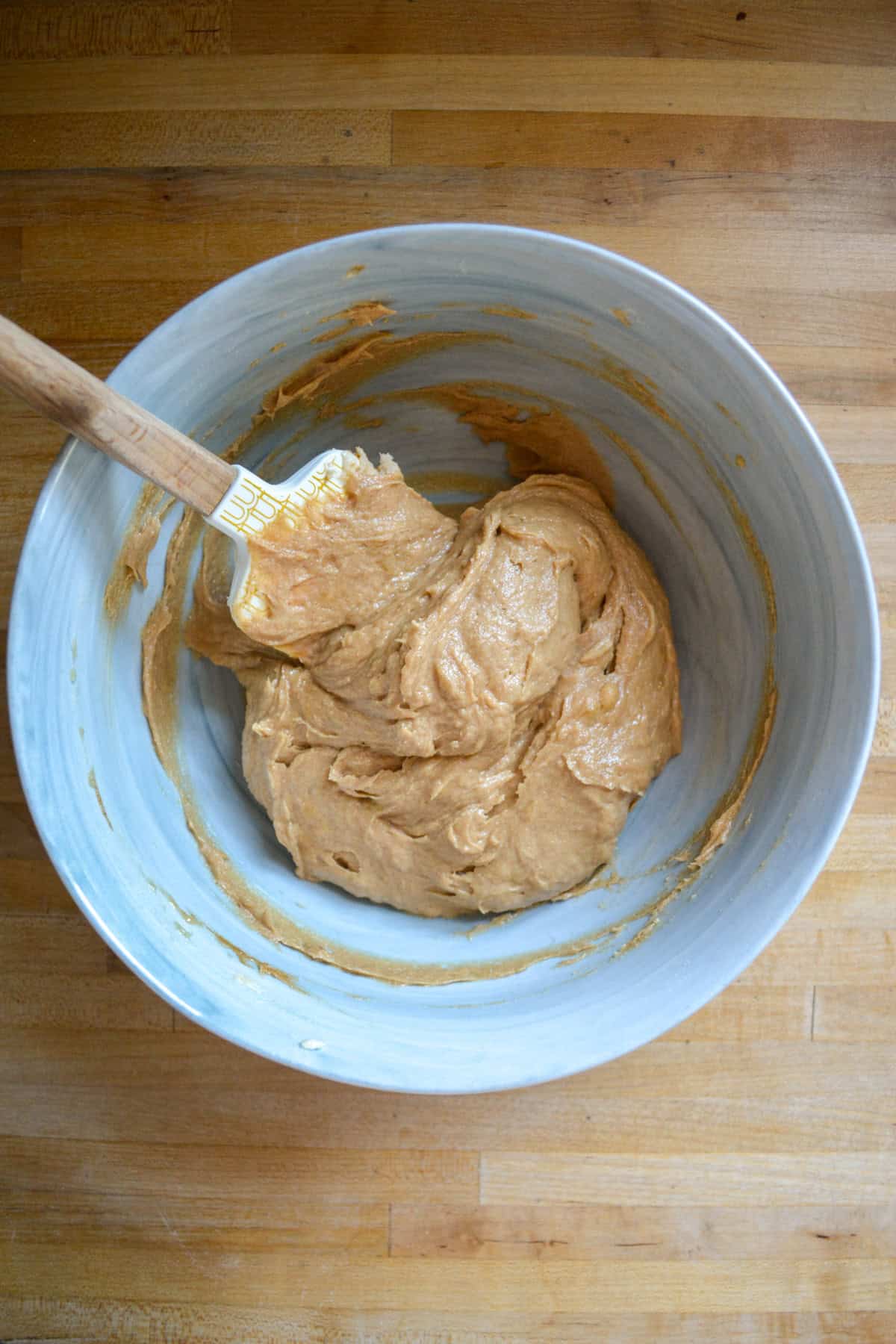Peanut butter and mashed banana mixed into the butter and sugar in a large mixing bowl.