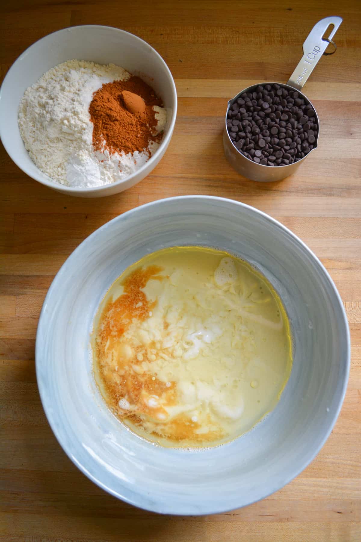 Ingredients for making this recipe in bowls on a wooden surface.