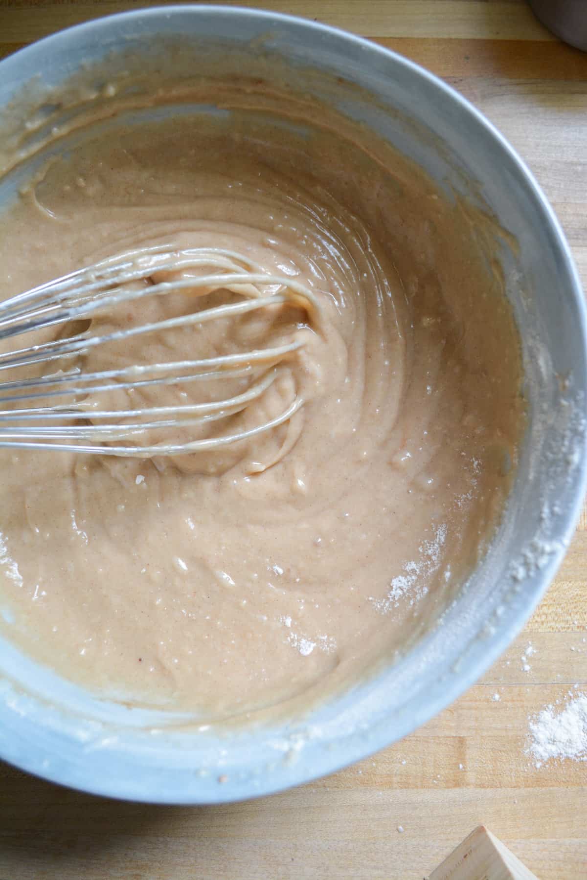 Batter in a marble bowl with a whisk.