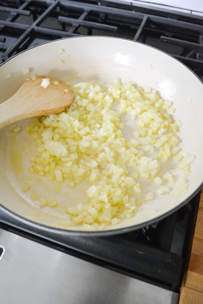 Onions and garlic sautéing in a large pan
