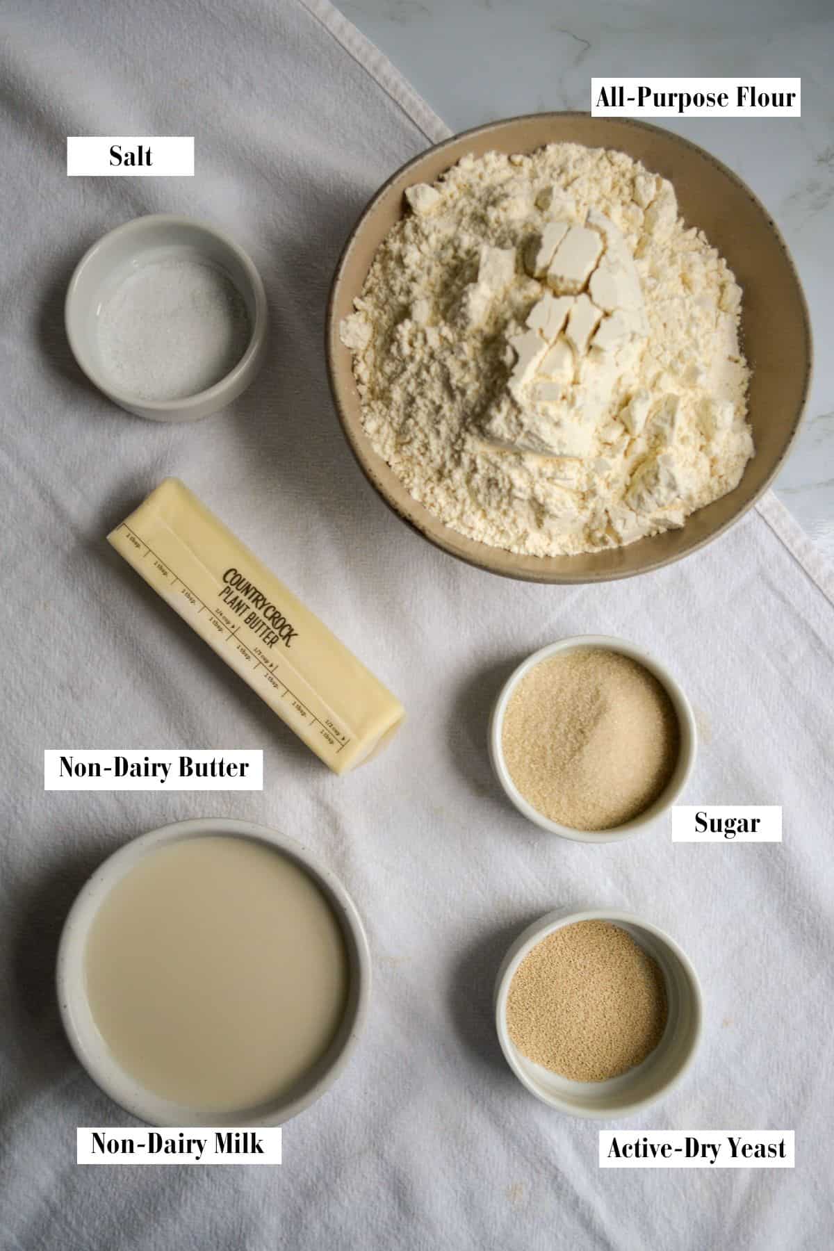 Ingredients for making this recipe in small bowls on a linen cloth.