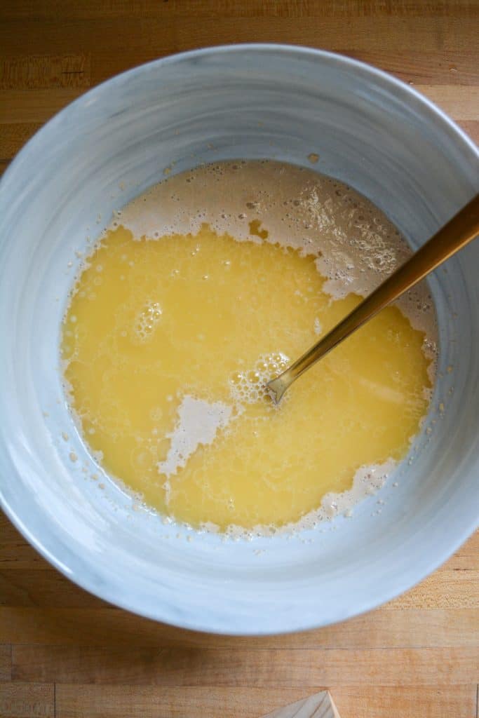 Wet ingredients for dairy free yeast rolls in a marble bowl