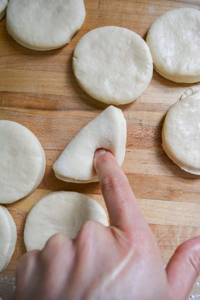 a finger sealing the dough by pressing into it.