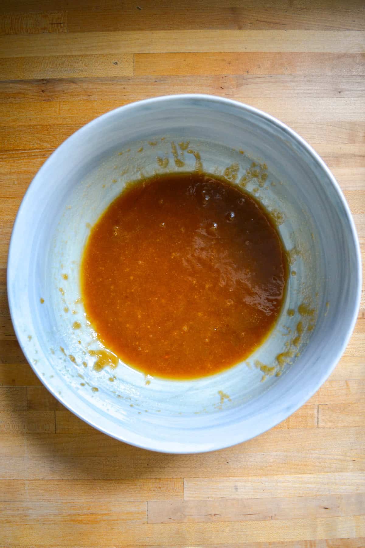 Melted vegan butter and brown sugar whisked together in a bowl.