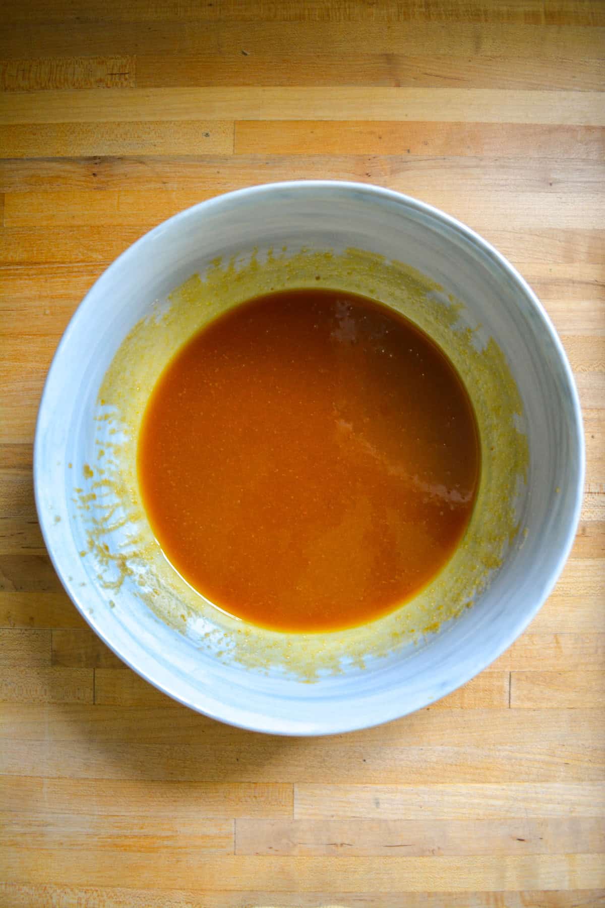 Pumpkin puree added to the vegan butter and brown sugar in a large bowl.