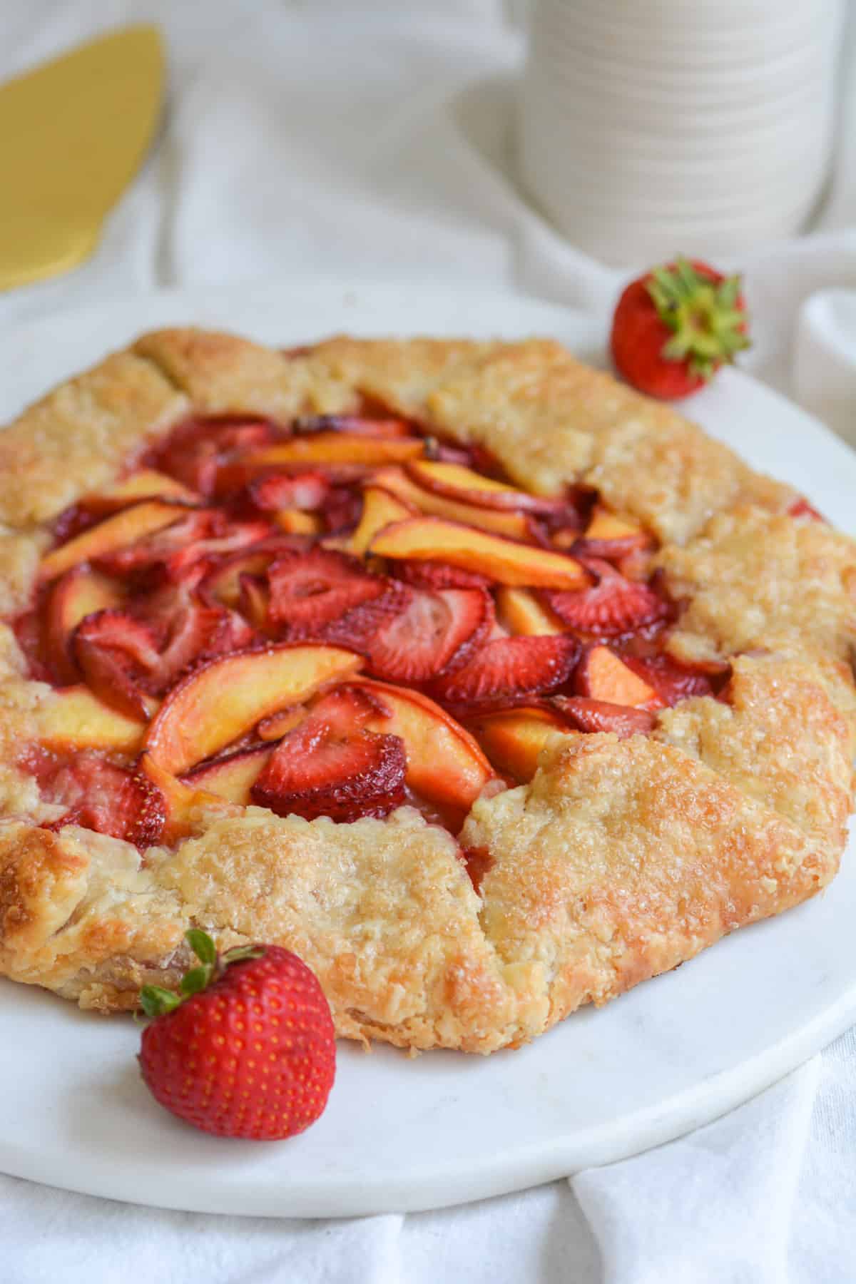 Vegan Strawberry Peach Galette on a marble board