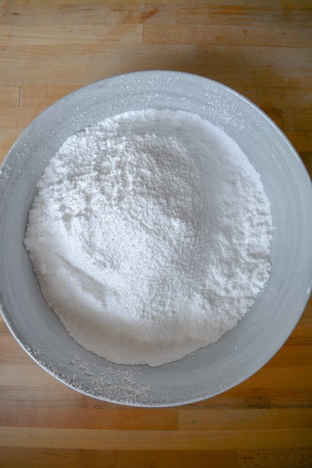 Sifted powdered sugar in a marble bowl.