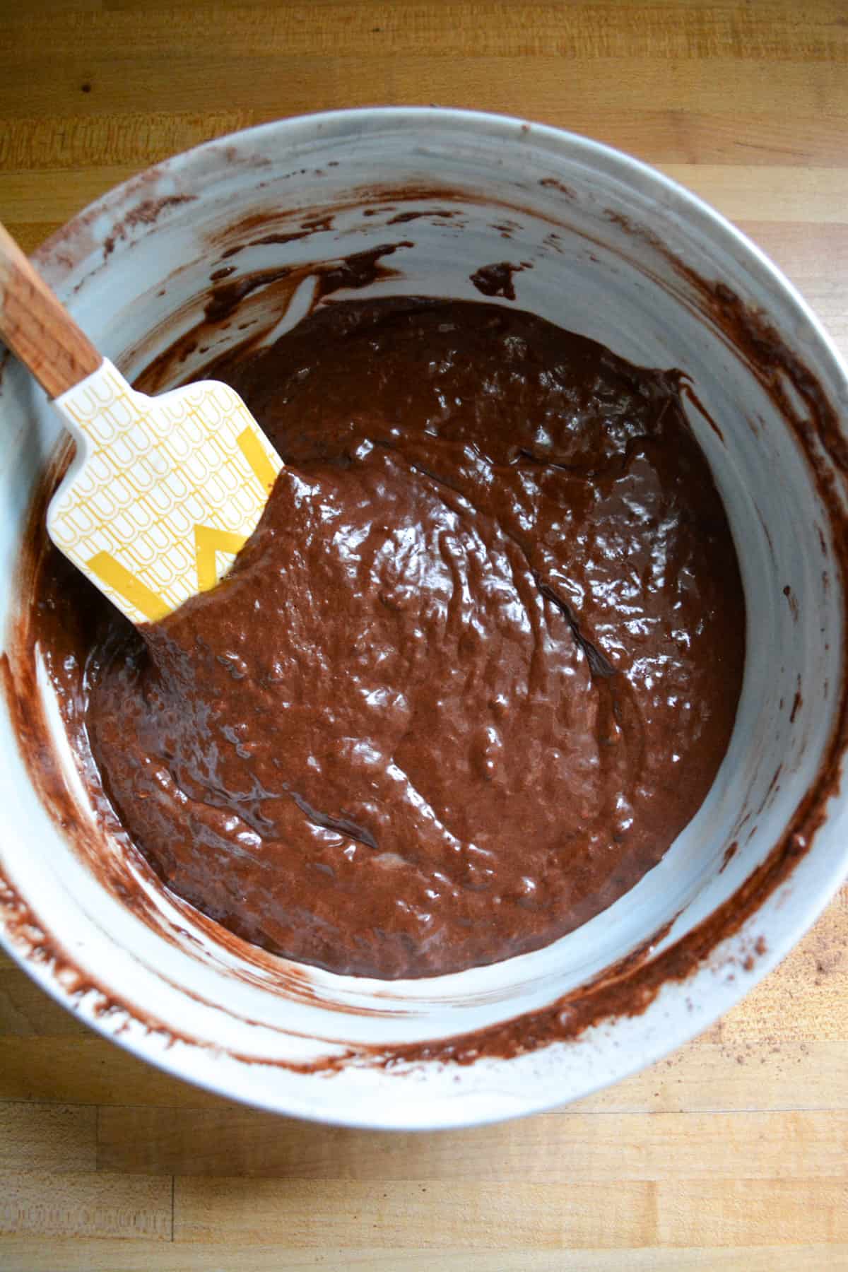 Overhead photo of chocolate batter in a marble bowl.