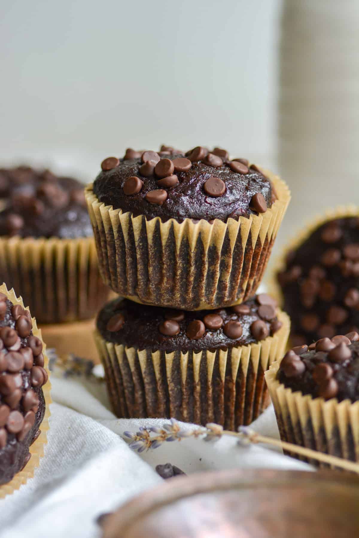 Two vegan double chocolate chip banana bread muffins stacked on top of each other.