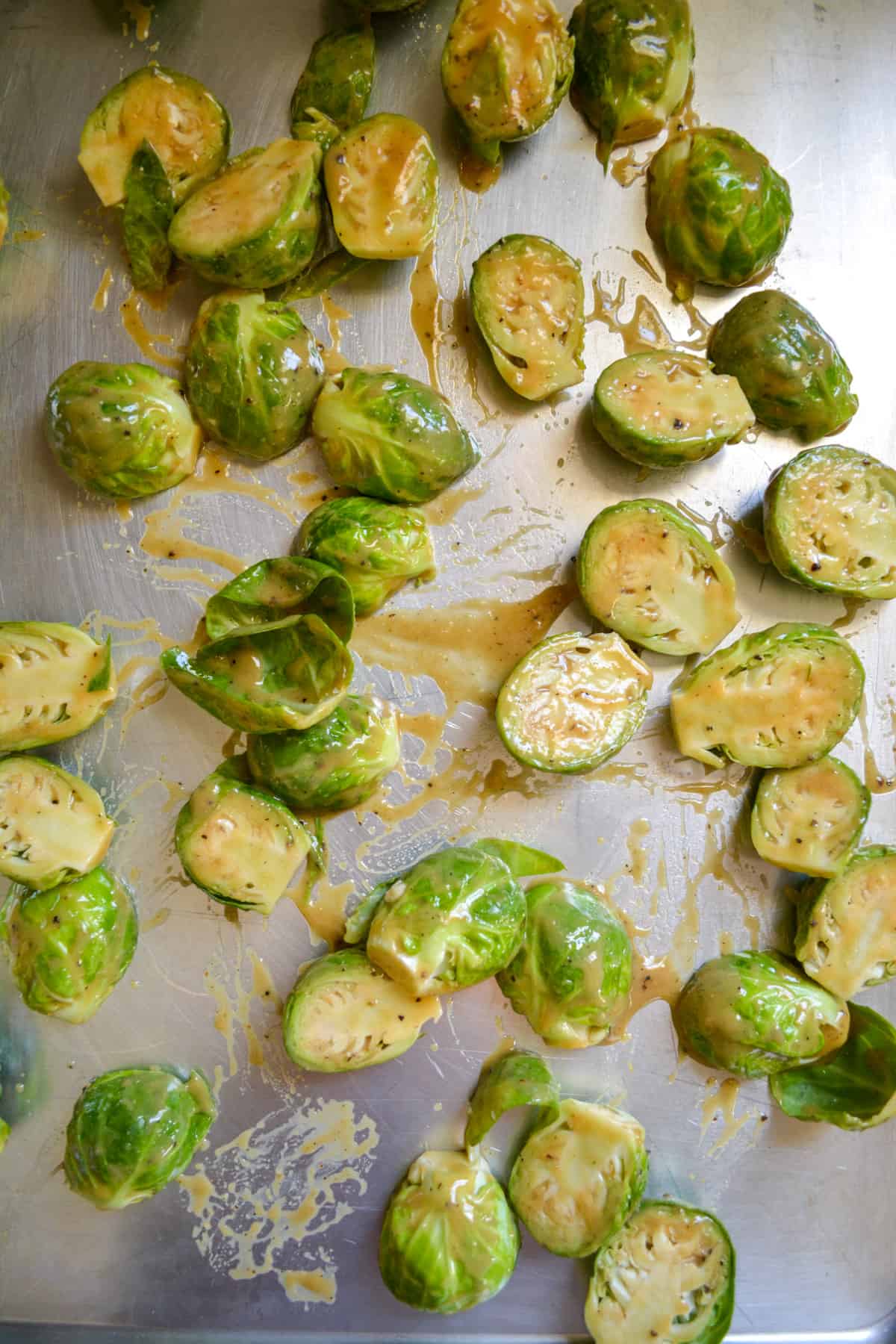 Overhead photo of Brussels sprouts on a baking sheet ready to roast.