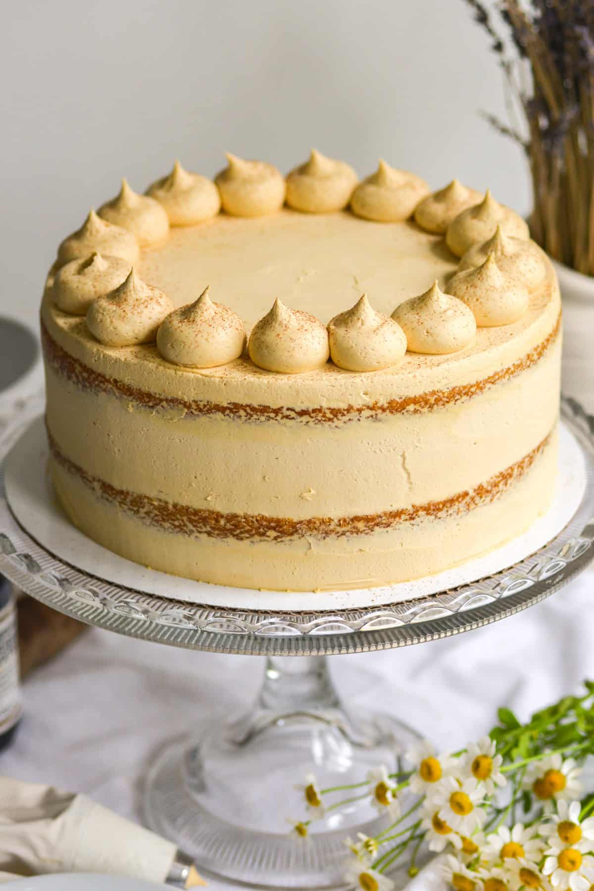 Vegan Pumpkin Layer Cake on a glass cake stand.