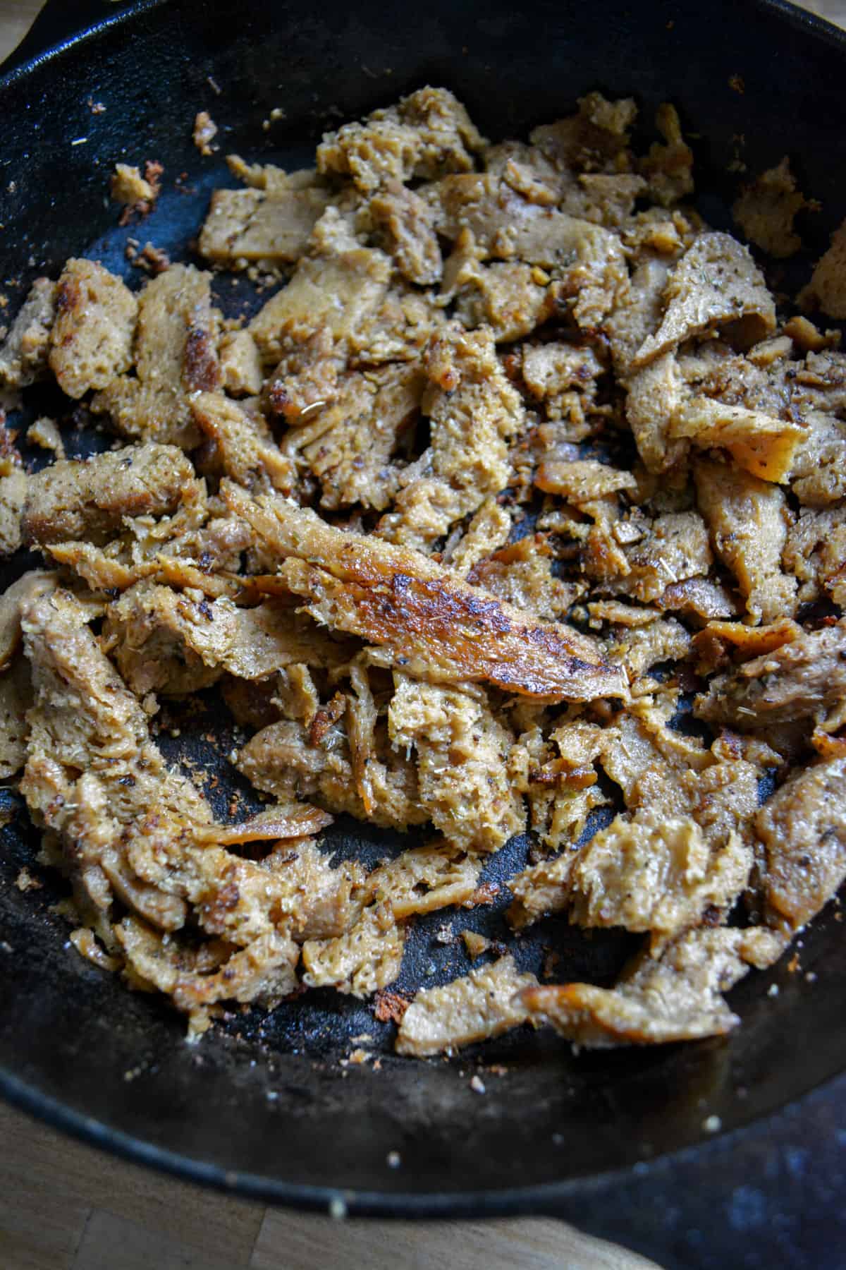 Seitan finished cooking in a cast iron skillet.