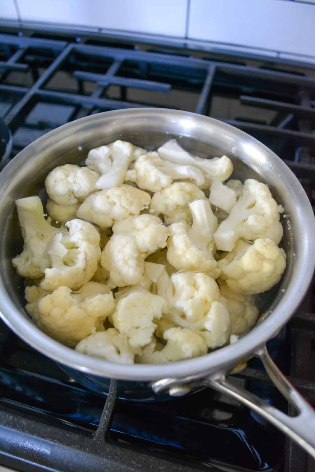Cauliflower florets in a port of simmering water.