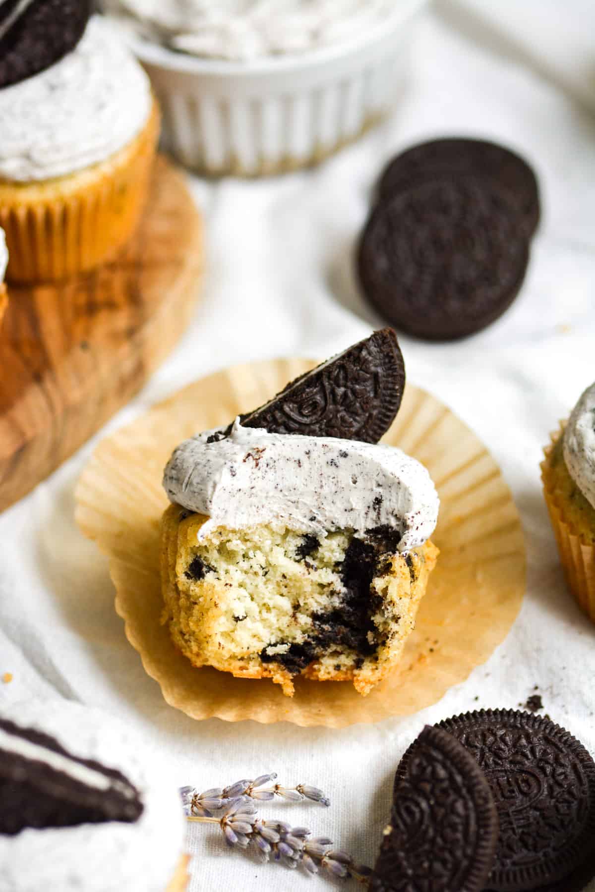 A Vegan Oreo Cupcake with a bite taken out of it on its wrapper.