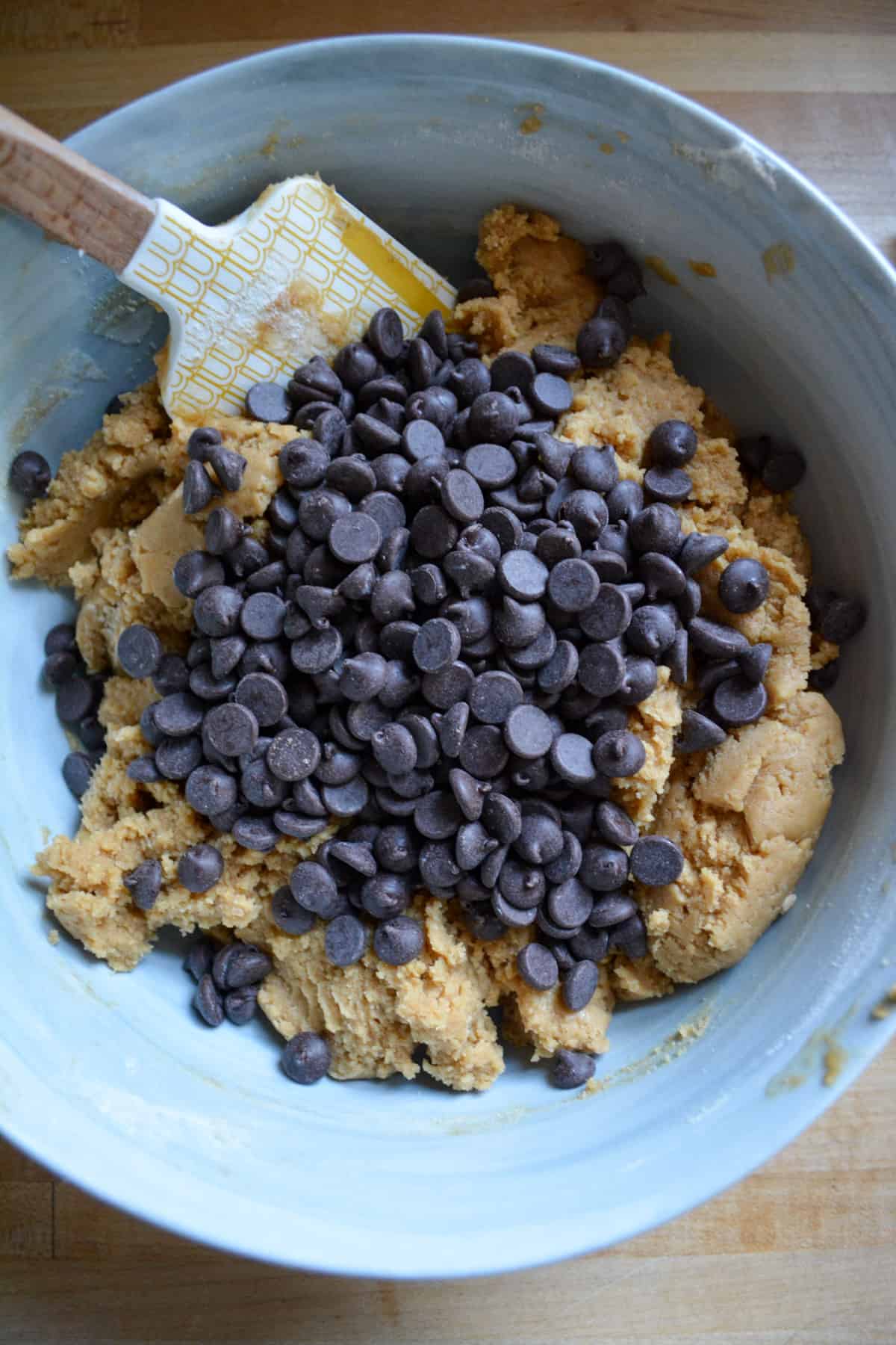 Overhead photo of vegan peanut butter chocolate chip cookie dough in a bowl.