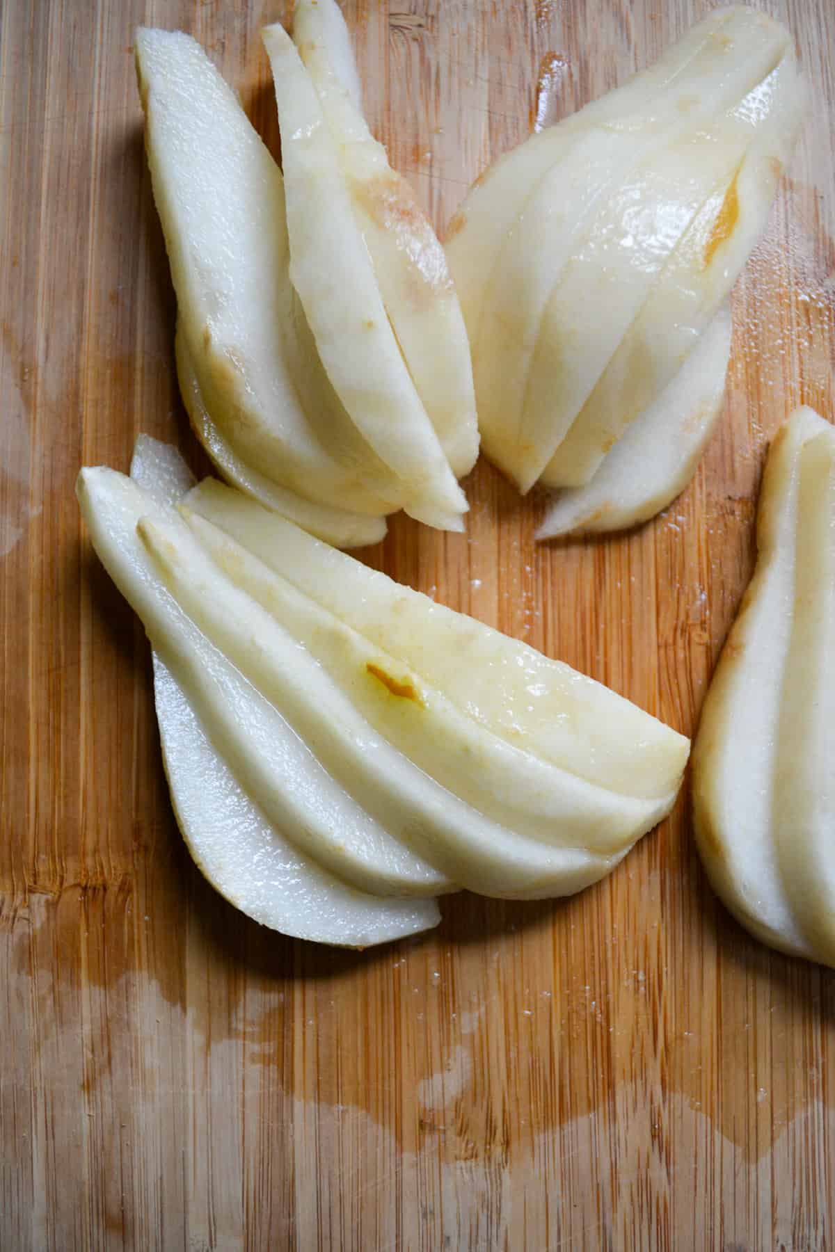 Overhead photo of a pear that has been peeled and sliced.