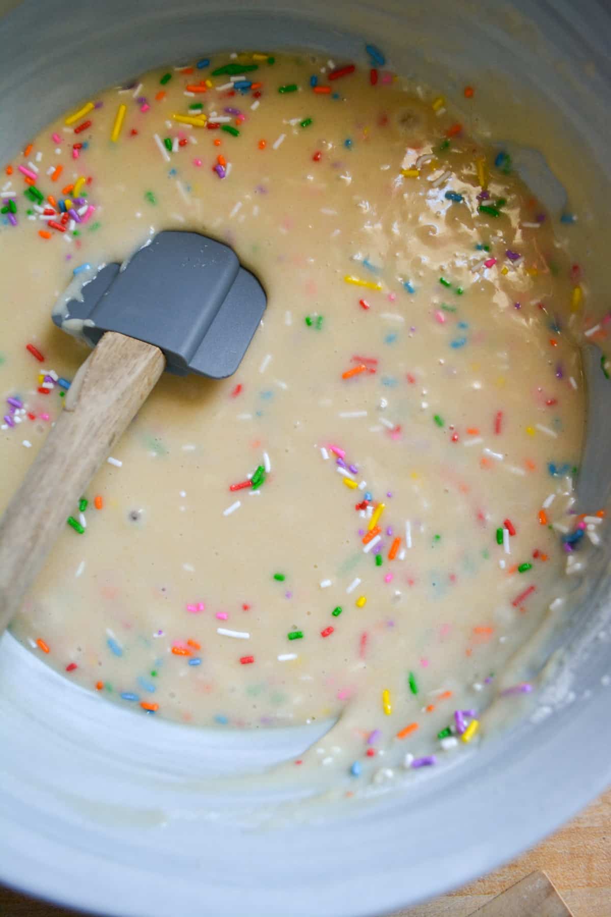 Rainbow sprinkles mixed into the vegan funfetti cake batter.