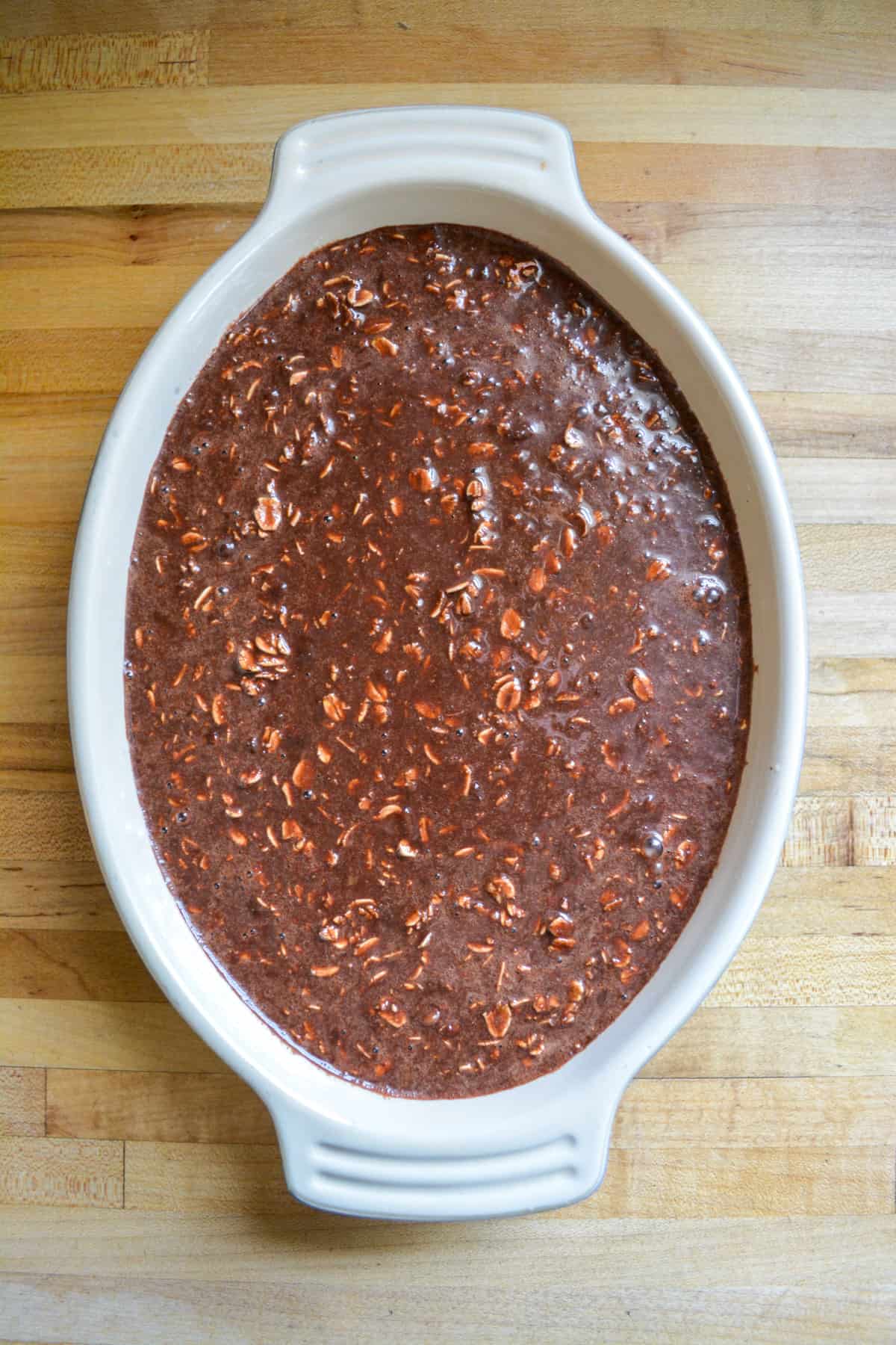 Chocolate oats poured into a baking dish.