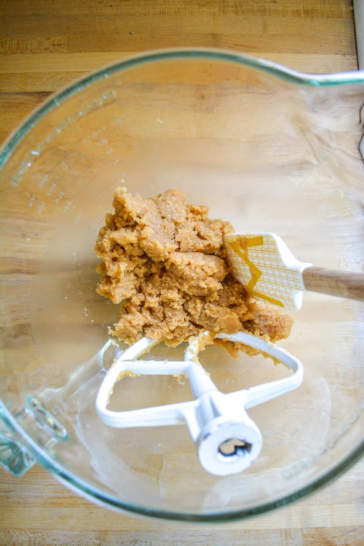 Coconut oil and brown sugar mixed together in a glass bowl.